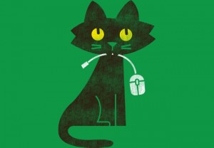 a cat with a computer mouse in its mouth