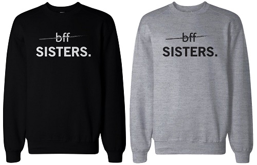 matching sweaters both say "sisters" with "bff" crossed out