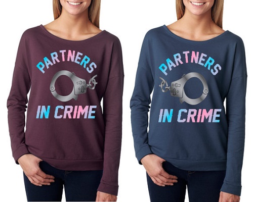 Matching sweaters say "Partners in crime" with pair of handcuffs.