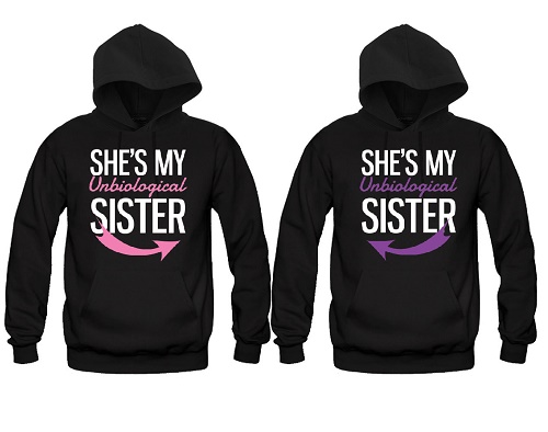 Matching sweaters, both say "She's my unbiological sister" with arrows pointing toward each other