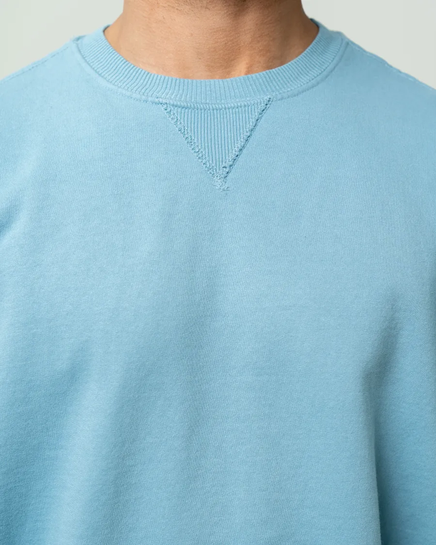 Closeup of a PC098 Port & Company Pigment Dyed Crewneck Sweatshirt